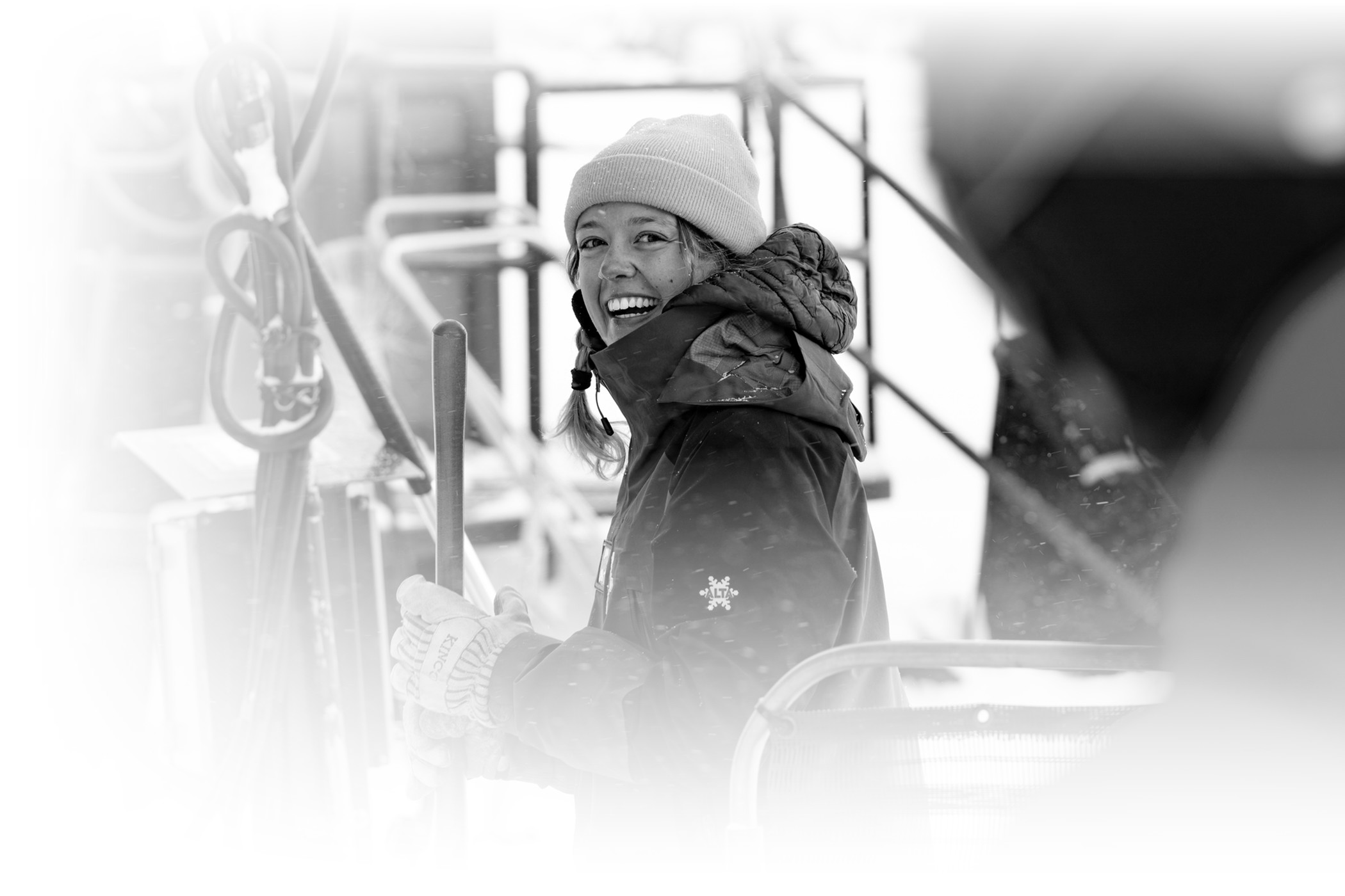 An Alta Ski Area employee smiles while working on a snowy winter day at Alta Ski Area