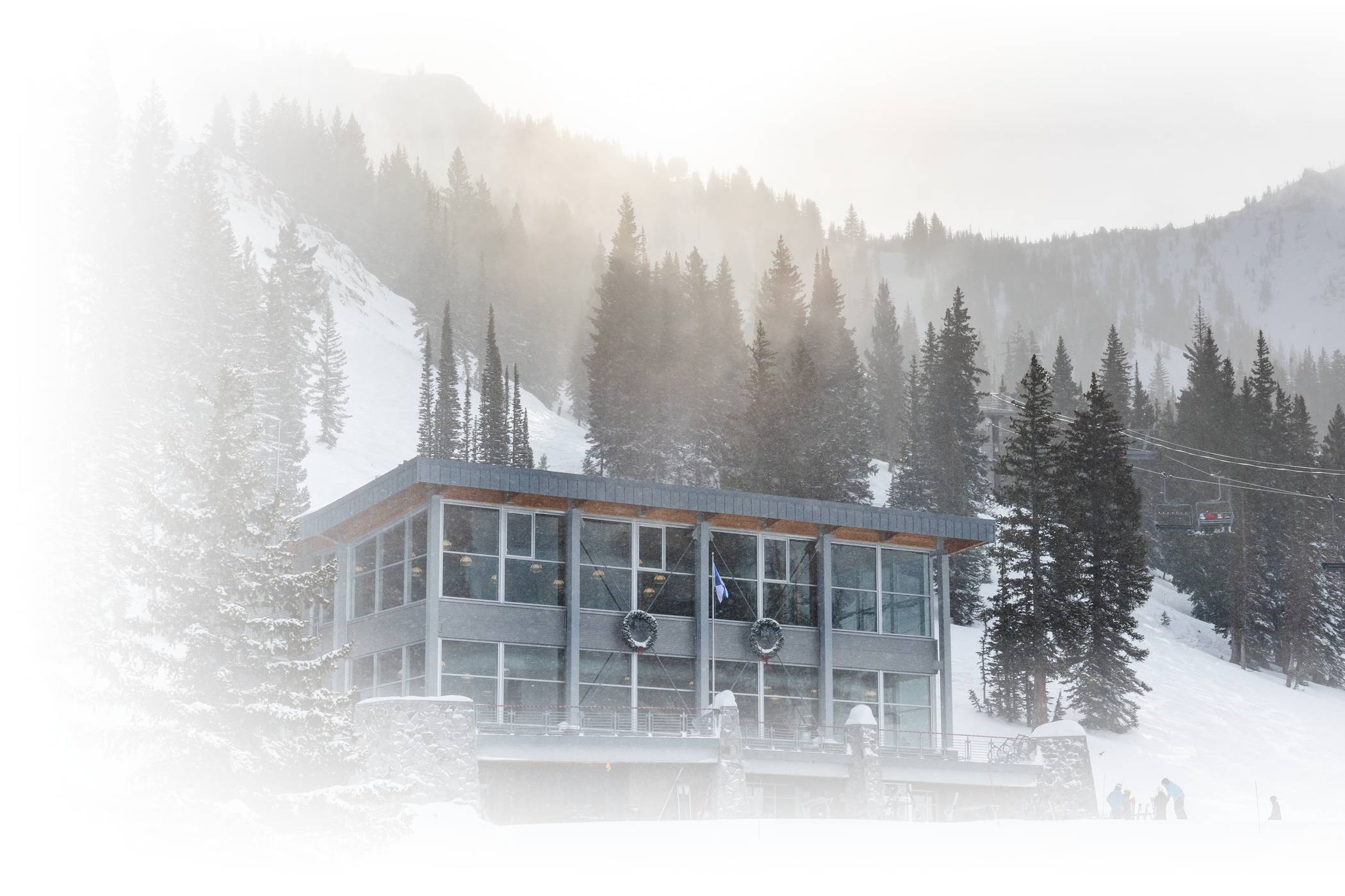 Skiers dine at Watson Shelter on a sunny winter day at Alta Ski Area